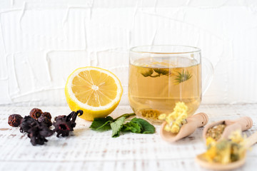 Dry herbs in wooden spoons, dogrose, chamomile, calendula, St. John's wort, hibiscus, lemon balm,...