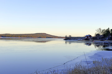 A little wood house beside the lake Inari in Finland