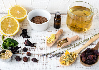 Dry herbs in wooden spoons, dogrose, chamomile, calendula, St. John's wort, hibiscus, lemon balm,...