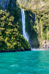 Fototapeta na wymiar Waterfall in Milford Sound's fiord land in the south island of New Zealand.