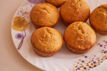 Homemade cupcakes lie on a white plate