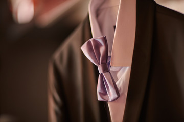 wedding suit for the groom with a purple bow tie