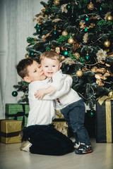 two children under the christmas tree