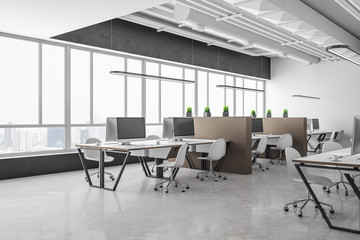 Modern coworking office interior with equipment on desktop