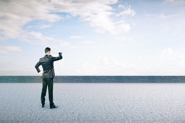 Businessman on concrete ground