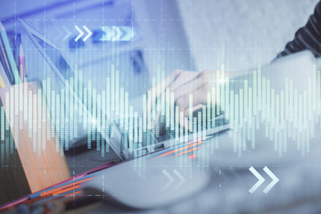 Double exposure of woman hands typing on computer and forex chart hologram drawing. Stock market invest concept.