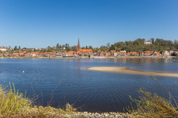 Obraz premium View over historic city Lauenburg from across the river Elbe in Germany