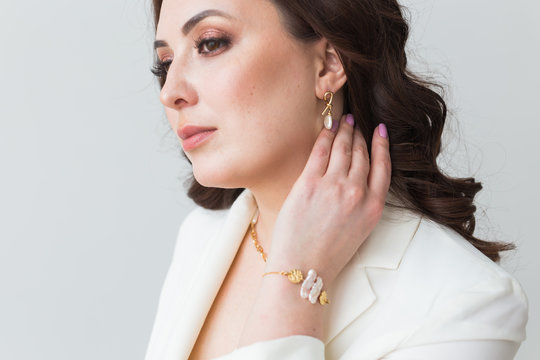Elegant woman with earrings, close up portrait. Accessories, jewelry and bijouterie concept.