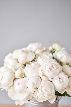 White Odile peonies in a metal vase. Beautiful peony flower for catalog or online store. Floral shop concept . Beautiful fresh cut bouquet. Flowers delivery. Copy space