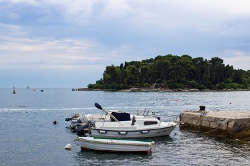 Fototapeta na wymiar Rovinj, Croatia; 7/18/2019: Some boats on the Adriatic Sea, anchored in the coast of the old town of Rovinj