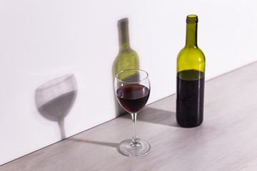 Shadow of wine glass in dark light.