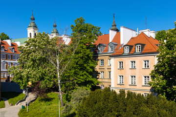 Panoramic view of historic tenement houses at Mostowa street of Starowka Old Town quarter with Church of Holy Spirit in background - Warsaw, Poland © Art Media Factory