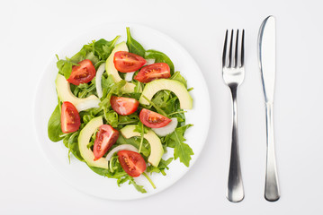 Healthy diet concept. Top above overhead close-up view photo of a salad plate with olive oil fork and knife aside isolated on white background