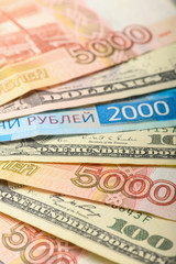 Cash banknotes background. The background of the American and Russian money banknotes. Dollars and rubles background.