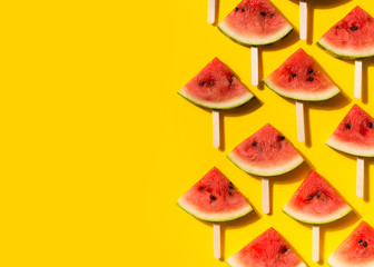 Watermelon slices flat lay on yellow background