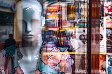 Showcase closed clothing store with woman man dummy. Bankruptcy losses ruin suffered by business...