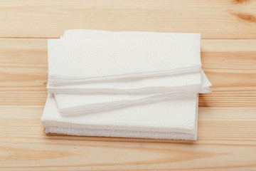 white paper napkin or tissue on the wooden table background.