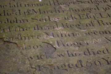 Weather-beaten old tombstone lettering