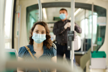 Woman in medical mask sitting in streetcar
