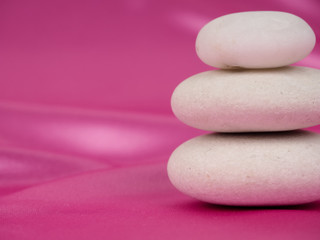 Obraz na płótnie Canvas Zen stones on a pink background, Studio shot of rocks balancing on one another