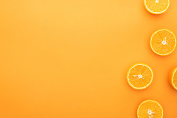 top view of juicy orange slices on colorful background