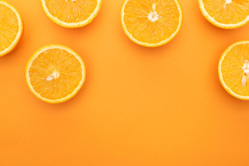 top view of ripe juicy orange slices on colorful background with copy space