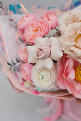 Bouquet of flowers from a peony rose, ranunculis, peony and eustoma. Beautiful bouquet in soft pink colors. Stylish bouquet of flowers in a box. Flower concept.