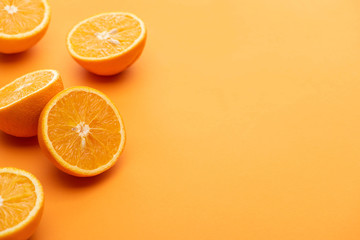 ripe delicious cut oranges on colorful background