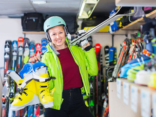 Portrait of girl in helmet and jacket who is demonstrating ski a