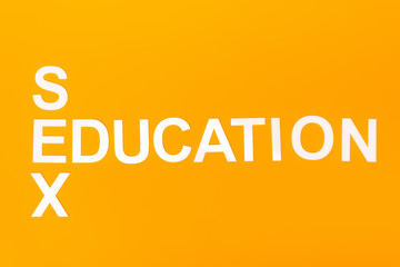 top view of white sex education lettering isolated on orange