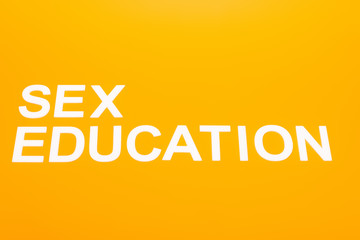 top view of sex education lettering isolated on orange