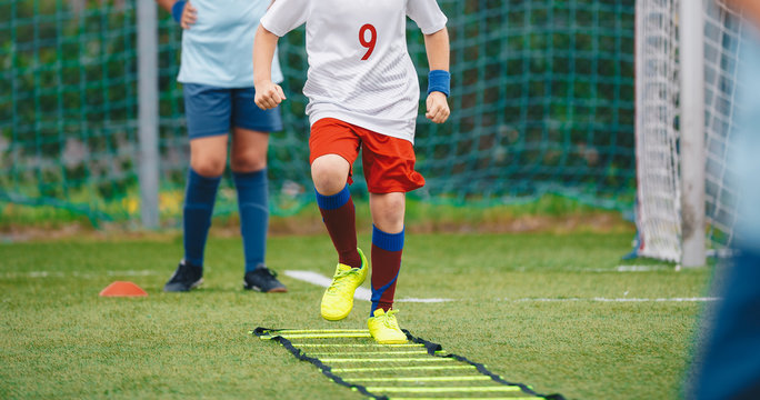 Kids exercising on sports school field during physical eduacation class. Boys is sports clothes on outdoor physical training