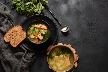 Fresh fish soup on black background