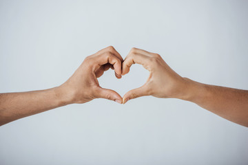Cropped view of men gesturing love sign isolated on grey