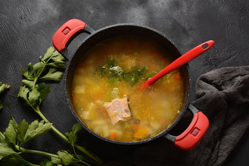 Fresh fish soup on black background