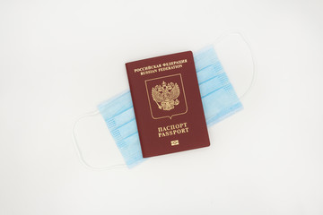 The passport is on a medical bandage on a white background. The concept of modern reality in the context of a pandemic, the crown of the virus, self-isolation, protection and security.