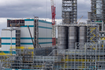 Type of metal structures of a large plant, overpasses, communications, cranes, pipes. Large-scale view from a height.