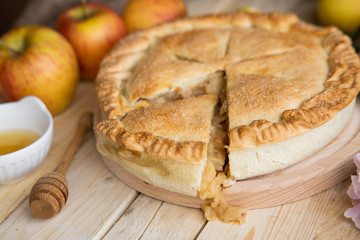 Apple pie on a wooden background, selective focus. Homemade American Pie from Organic Autumn Apples.