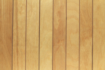 Texture of light wood vertical boards with space for text caption. The wooden surface is designed in the loft style.