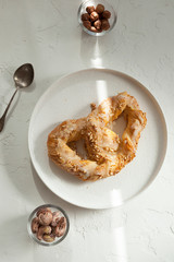sweet pretzel with icing and nuts, sweet pastries 