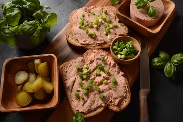 Chicken or goose liver pate sandwiches on a wooden board