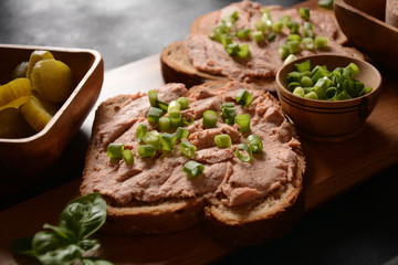 Chicken or goose liver pate sandwiches on a wooden board