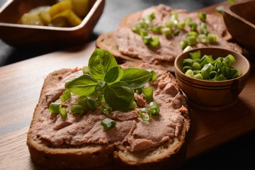 Chicken or goose liver pate sandwiches on a wooden board