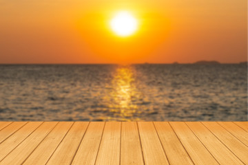 Beautiful perspective wood board with blurred Ocean and sunset scene on background