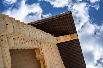 house made of logs perspective view of the background of the sky fragment, wood construction