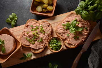 Chicken or goose liver pate sandwiches on a wooden board