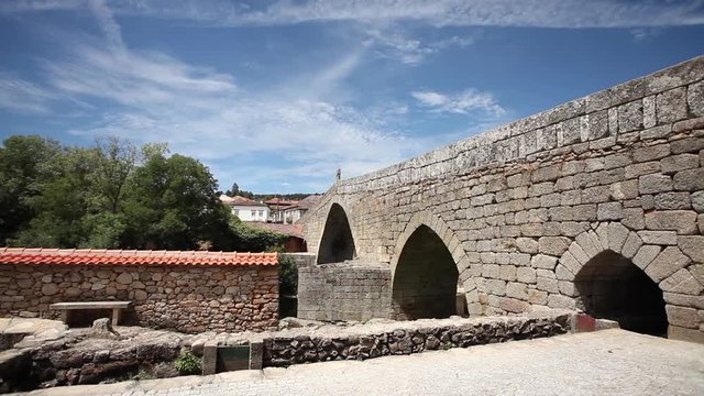 alongside shot of Roman Bridge with two arches in Ucanha, Portugal