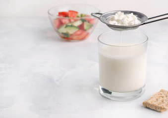 Obraz na płótnie Canvas Fermented milk product drink kefir in a glass on a white background. Healthy breakfast concept