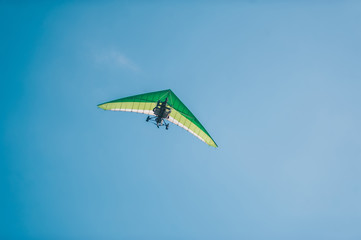Fototapeta na wymiar The motorized hang glider in the clear blue sky