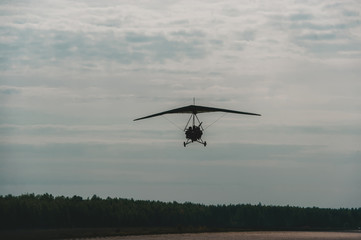 Fototapeta na wymiar The motorized hang glider ready to landing